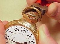Using a bow opener tool to open a pocket watch case back
